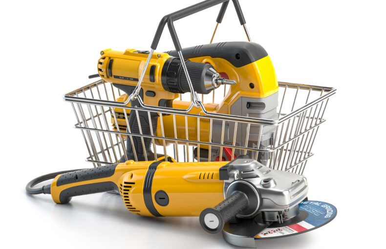 Shopping basket with elecric tools and construction equipment angle grinder, electric drill and jigsaw isolated on white. Selling and buying online. 3d illustration